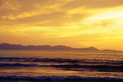 Scenic view of sea against romantic sky at sunset