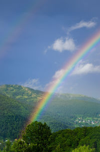 Rainbow over mountain against sky