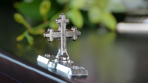 Close-up of cross on water