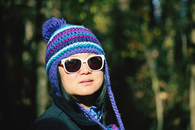 Portrait of mature woman wearing sunglasses standing outdoors