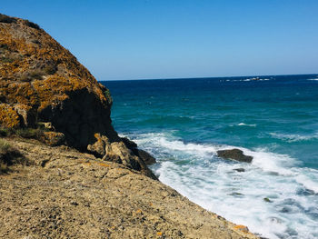 Scenic view of sea against clear blue sky