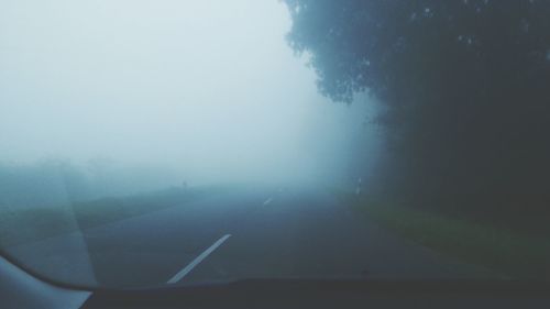 Scenic view of landscape against sky during foggy weather