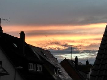 Silhouette buildings against sky at sunset