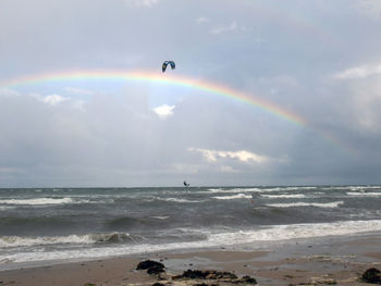 Scenic view of rainbow over calm sea