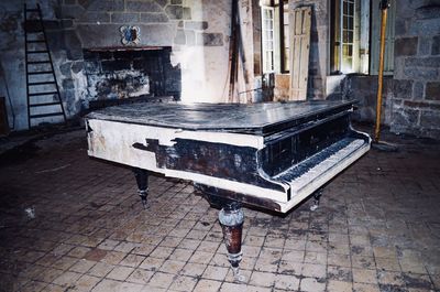 High angle view of child playing piano in abandoned building