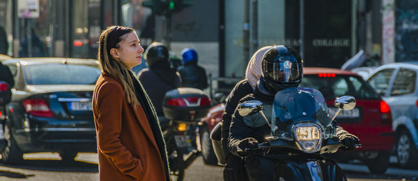 Woman standing on city street