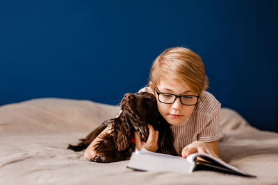 Portrait of young woman reading book