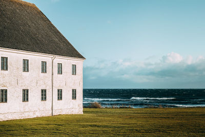 House by sea against sky