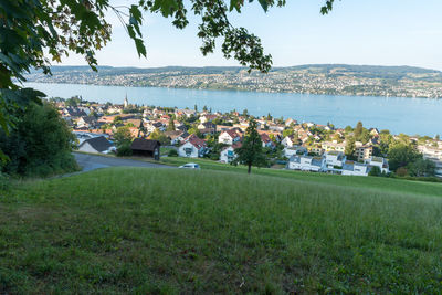 Scenic view of sea and townscape against sky