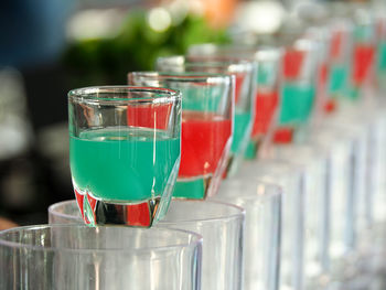Blue  and red cocktails in a shot glass on counter bar at hotel.