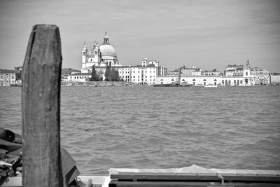 View of buildings by sea against sky