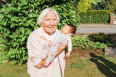 Portrait of senior woman with baby