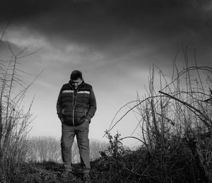 Full length of man standing on field against sky