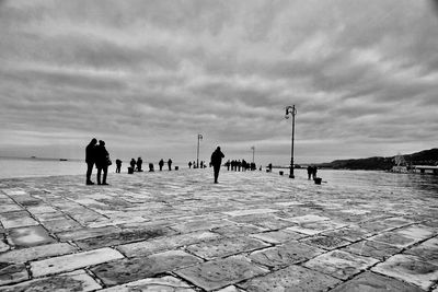 People on beach against sky