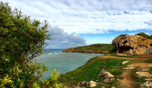 Scenic view of sea against cloudy sky