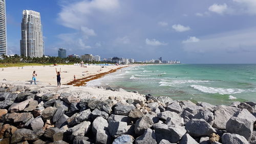 People on beach against sky