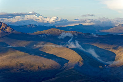 Scenic view of mountains against cloudy sky