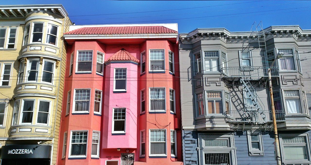 building exterior, architecture, built structure, window, residential building, residential structure, low angle view, building, balcony, house, city, apartment, day, exterior, clear sky, blue, outdoors, no people, sky, in a row