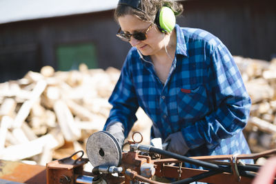 Mature woman working in sawmill