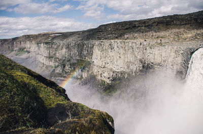 Scenic view of waterfall against sky