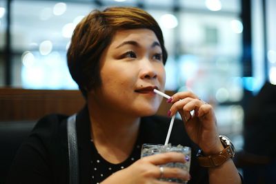 Woman having drink at restaurant