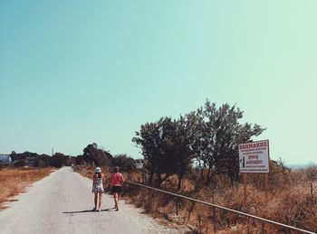 Empty road along trees