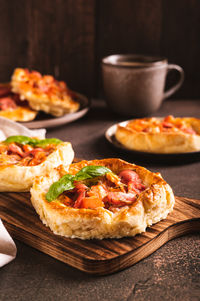 Chicago pizza pot pie with sausage, tomatoes and cheese on a board on the table vertical view