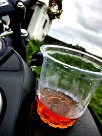 Close-up of beer in water against sky