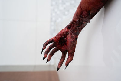 Cropped bloody hand of woman at home