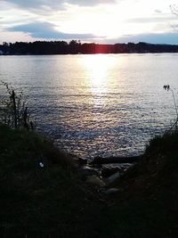 Scenic view of lake against sky during sunset