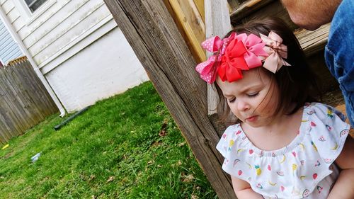 Low angle view of cute girl looking at camera