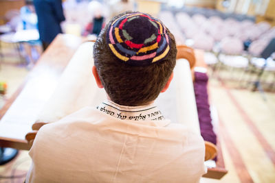 Rear view of jewish boy reading talmud