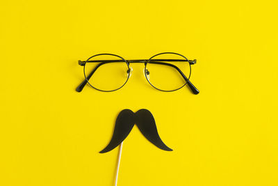 View of sunglasses against yellow background