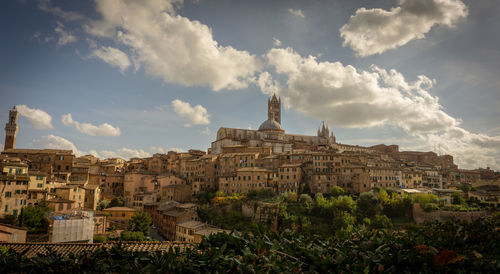 Old buildings in city against sky