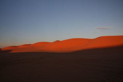 Scenic view of desert against sky during sunset