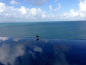 Scenic view of sea against cloudy sky