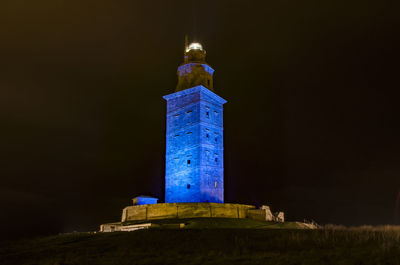 Low angle view of illuminated building against sky at night