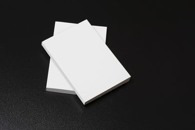 High angle view of white paper against black background