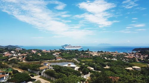 High angle view of city by sea against sky