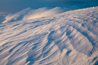 Aerial view of snowcapped mountains against sky