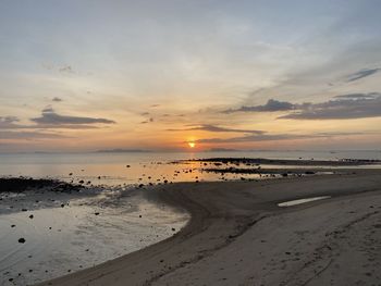 Scenic view of beach against sky during sunset