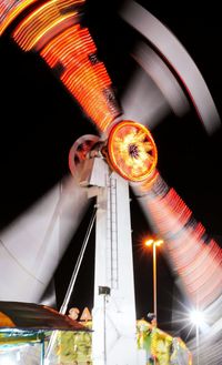 Low angle view of illuminated ferris wheel at night