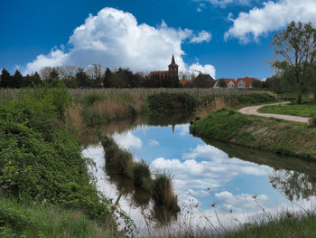 Panoramic view of lake and buildings against sky