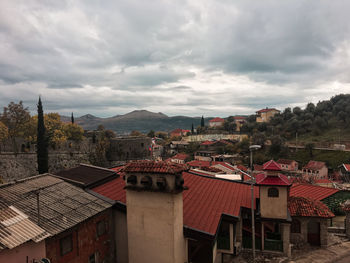 Houses in town against sky