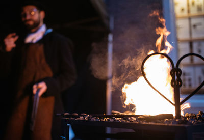 Blacksmith working at workshop