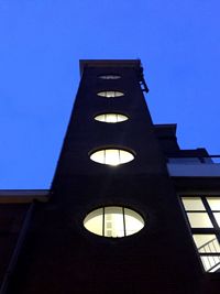 Low angle view of building against clear blue sky