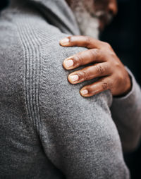 Midsection of man touching abdomen