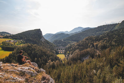 View of a tourist and the kalte rinne railway viaduct. rax-schneeberg group in styria, austria