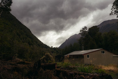 Scenic view of mountains and houses against sky