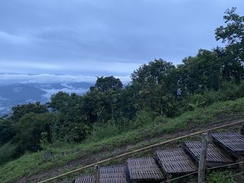 Railroad tracks by trees against sky